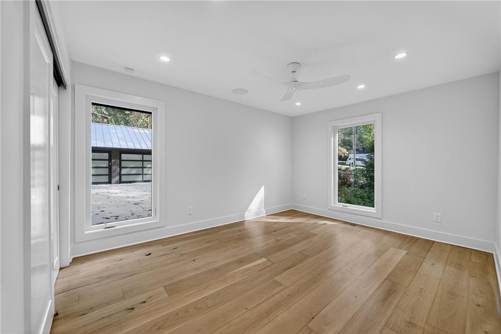 585 Amberidge Trail Northwest Atlanta, GA 30328 - Photo 59 of 103 a view of an empty room with wooden floor and a window