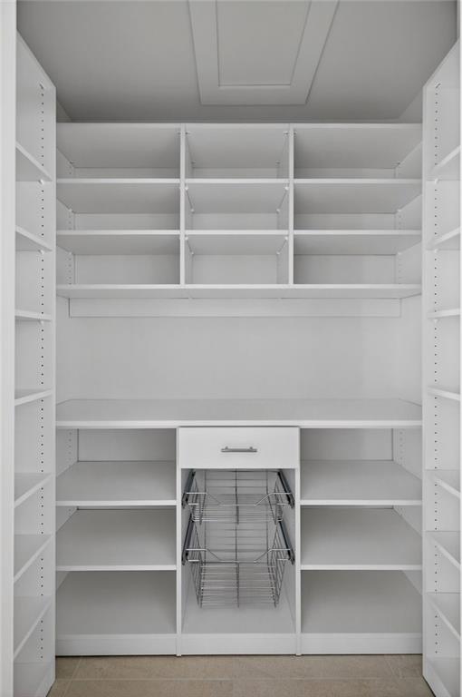 585 Amberidge Trail Northwest Atlanta, GA 30328 - Photo 60 of 103 a view of walk in closet with empty racks