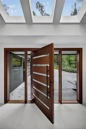 a living room with furniture a large window and a fireplace