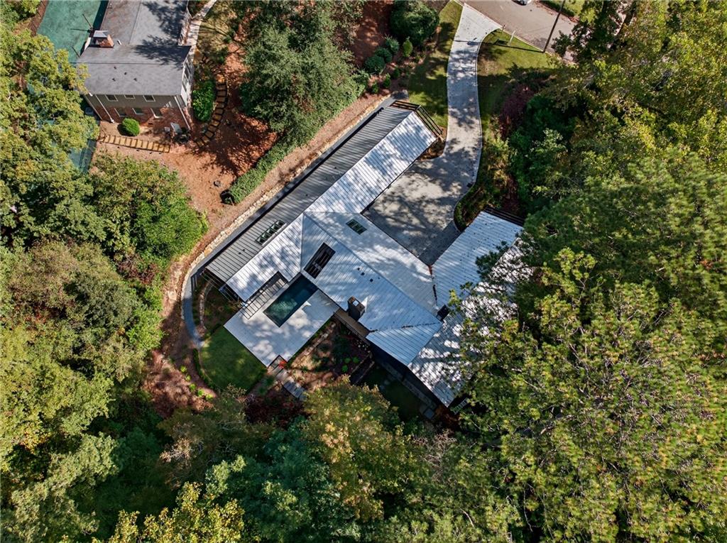 585 Amberidge Trail Northwest Atlanta, GA 30328 - Photo 82 of 85 an aerial view of a house with a yard and trees