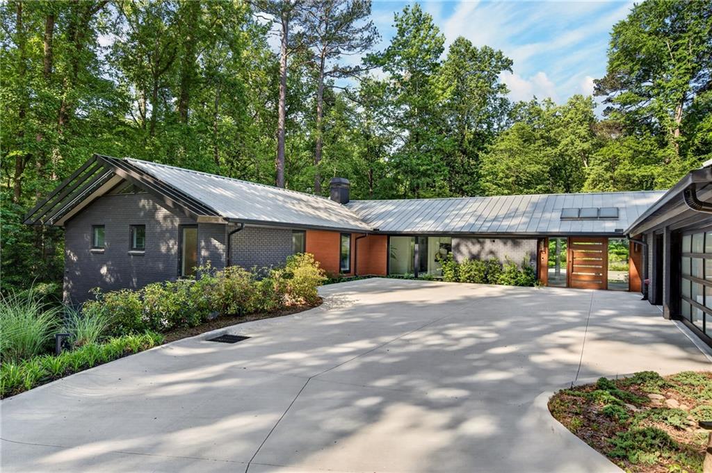 585 Amberidge Trail Northwest Atlanta, GA 30328 - Photo 84 of 85 a front view of a house with a garden