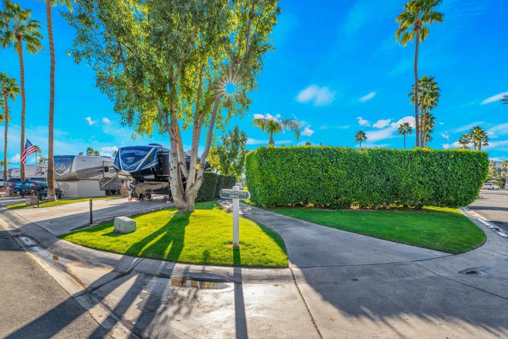 69411 Ramon Road, Unit 1158 Cathedral City, CA 92234 - Photo 2 of 18 a view of a swimming pool with a patio and a garden