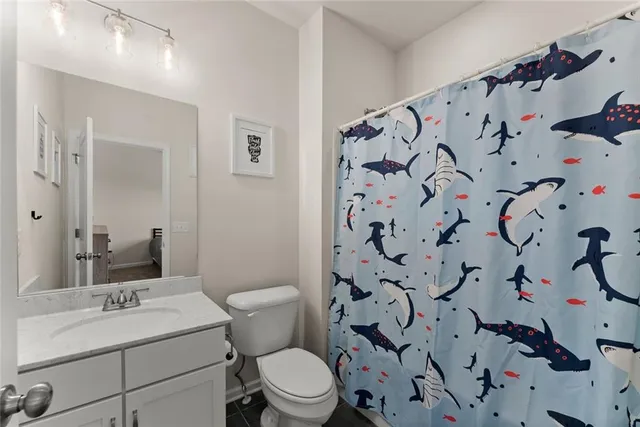 a spacious bedroom with a bed a couch and a large window