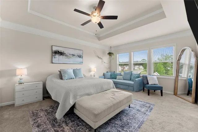 a bedroom with a bed a tv and a large window