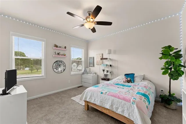 a bedroom with a bed and a television