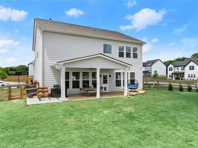 a view of a house with a yard and sitting area