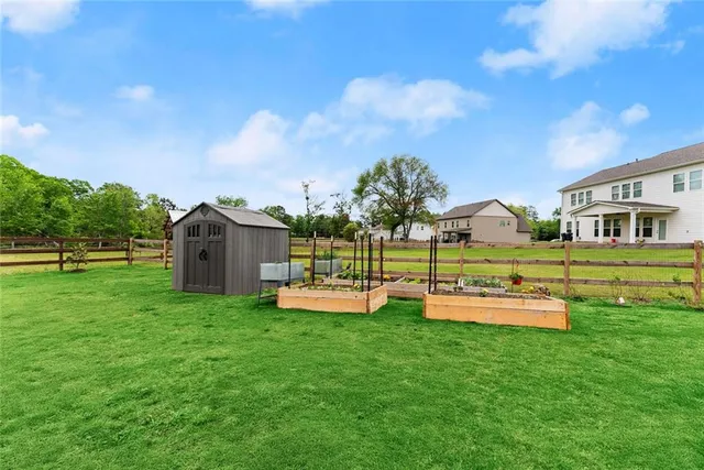 a view of a chairs and table in backyard of the house