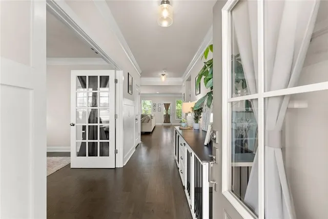 a view of a hallway with wooden floor and staircase