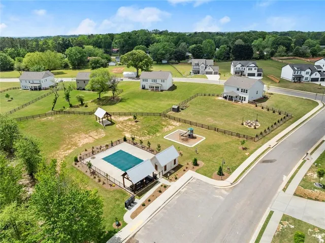 an aerial view of a house with a yard