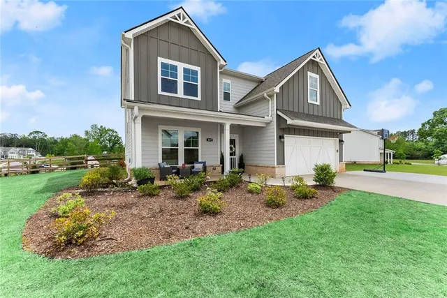 a front view of a house with a yard and garage