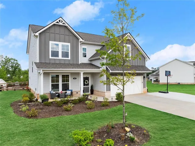 an aerial view of a house with pool outdoor seating and yard