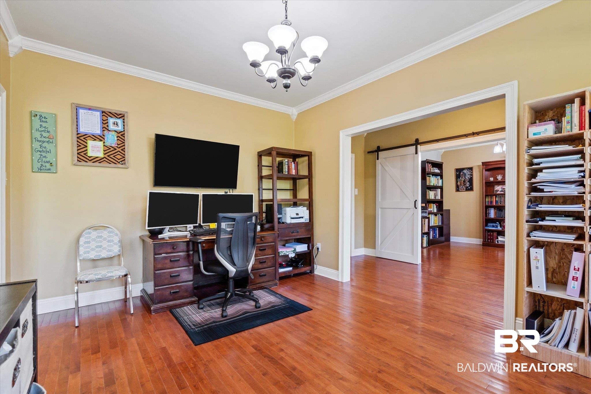 72 Limestone Drive Jackson, AL 36545 - Photo 15 of 38 Home office featuring a barn door, ornamental molding, a chandelier, and hardwood / wood-style flooring