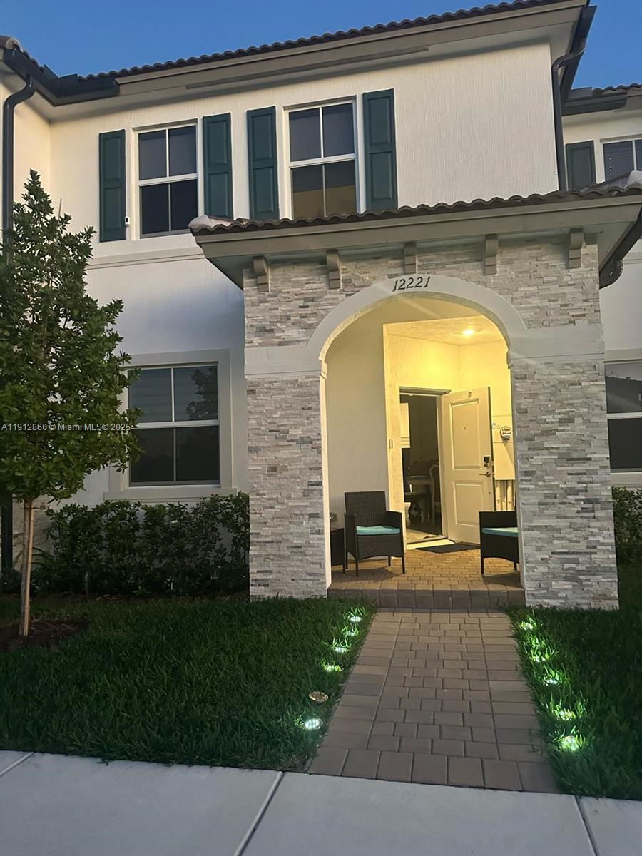 12221 Northwest 23rd Place Miami, FL 33167 - Photo 1 of 19 a front view of a house with garden