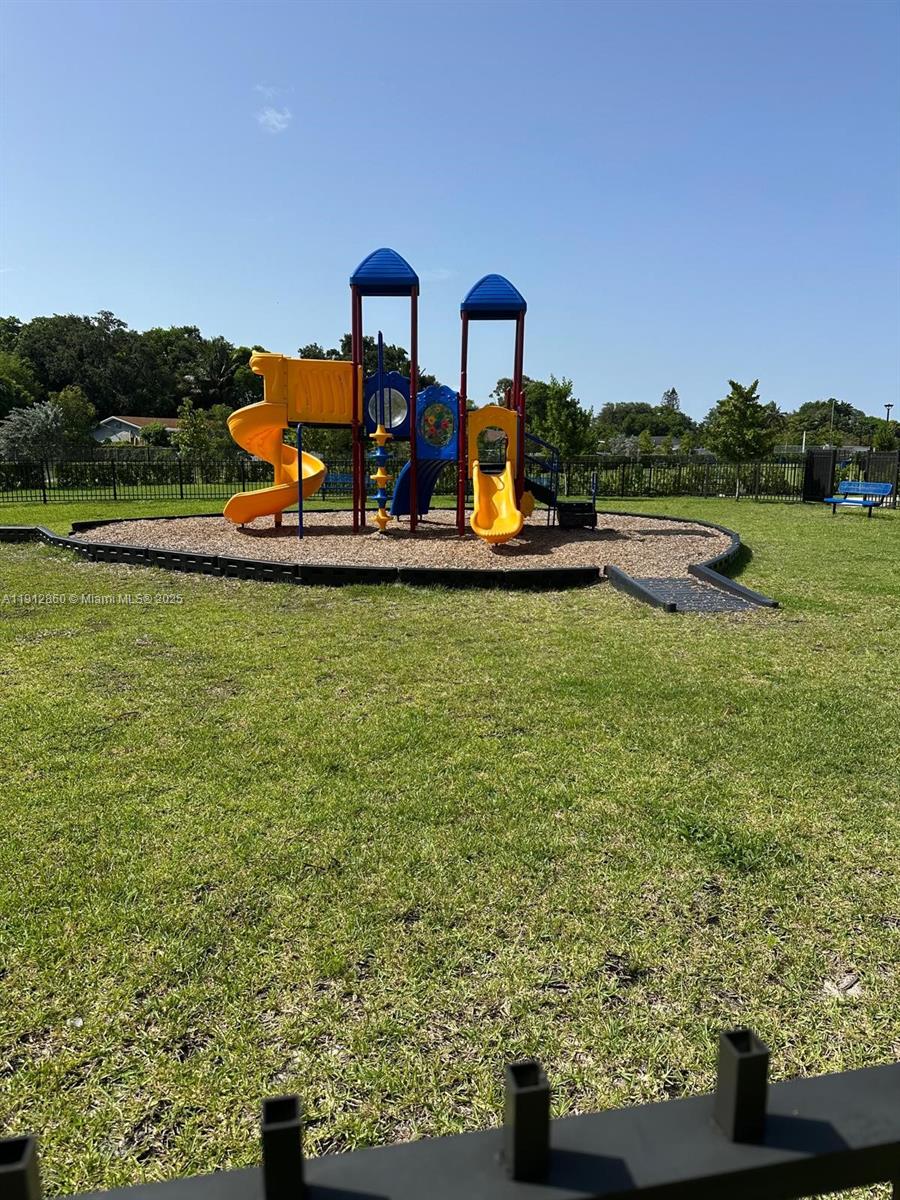 12221 Northwest 23rd Place Miami, FL 33167 - Photo 13 of 19 a view of a lake with a yard