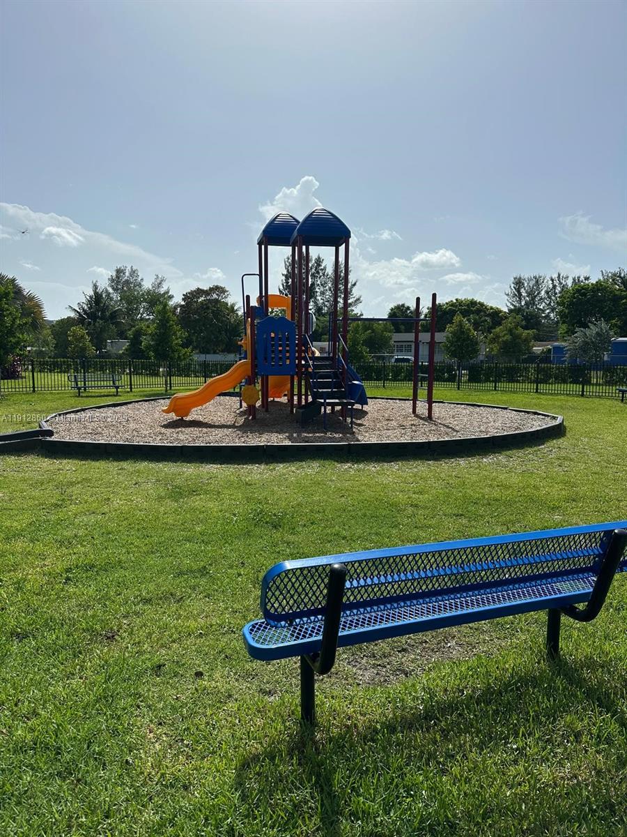 12221 Northwest 23rd Place Miami, FL 33167 - Photo 15 of 19 a view of a bench in a garden