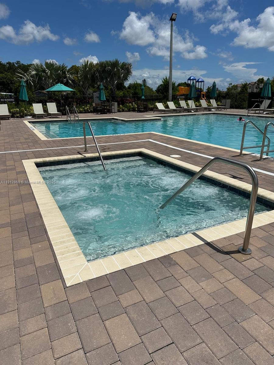 12221 Northwest 23rd Place Miami, FL 33167 - Photo 17 of 19 a view of swimming pool with outdoor seating and yard in the back