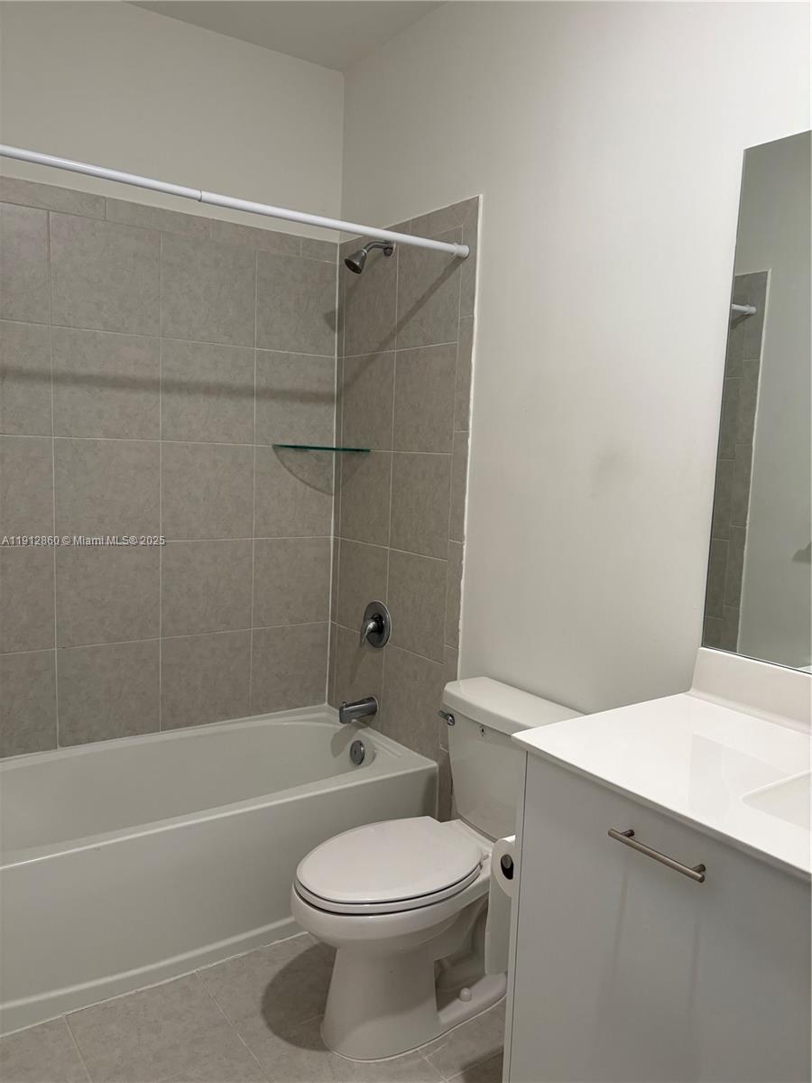 12221 Northwest 23rd Place Miami, FL 33167 - Photo 8 of 19 a bathroom with a sink a toilet and a bathtub