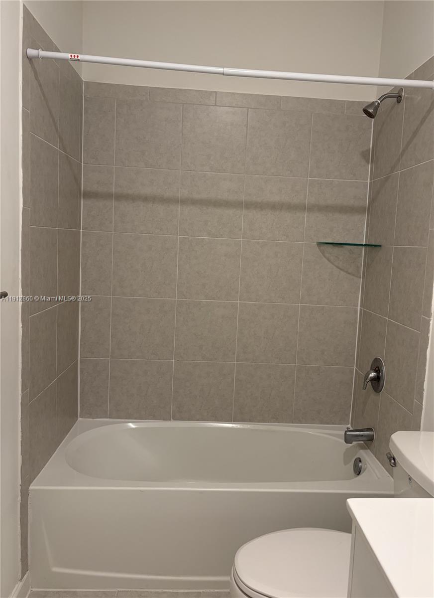 12221 Northwest 23rd Place Miami, FL 33167 - Photo 10 of 19 a bathroom with a toilet and a bathtub