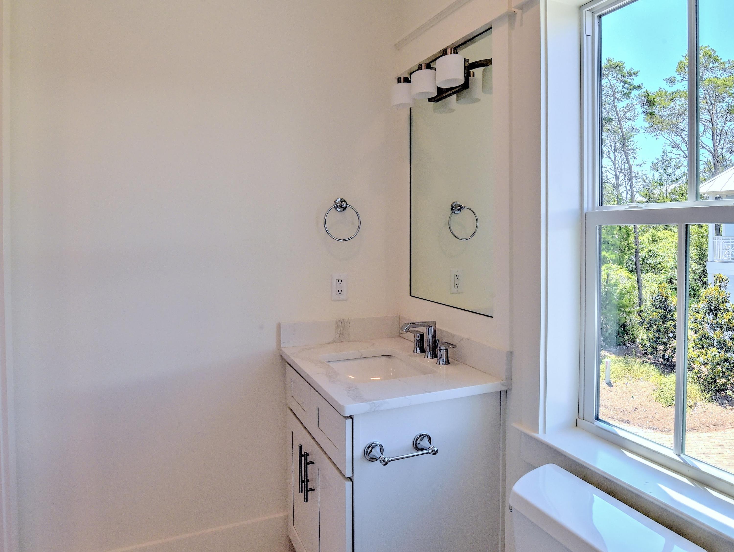 237 Cabana Trail Santa Rosa Beach, FL 32459 - Photo 19 of 27 a bathroom with a sink and mirror with window