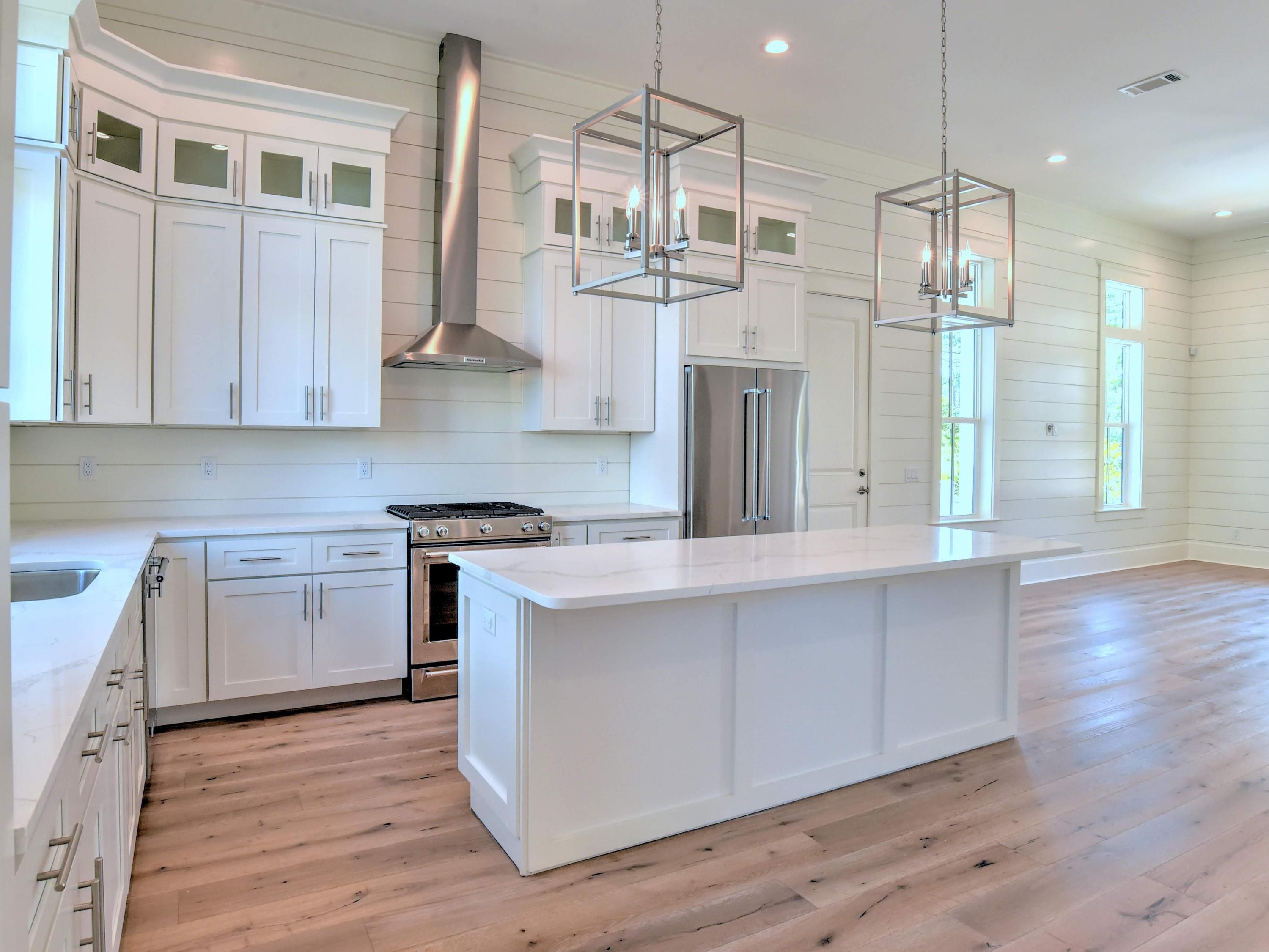 237 Cabana Trail Santa Rosa Beach, FL 32459 - Photo 6 of 27 a kitchen with stainless steel appliances granite countertop a sink a stove a refrigerator and cabinets