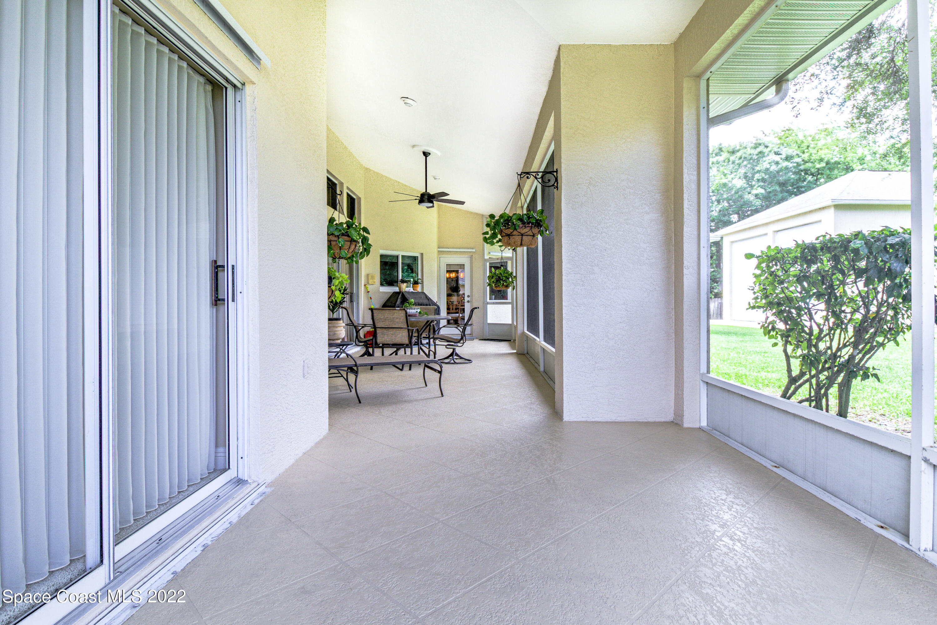 3415 Shady Run Road Melbourne, FL 32934 - Photo 29 of 45 a view of a porch with chairs and backyard of the house