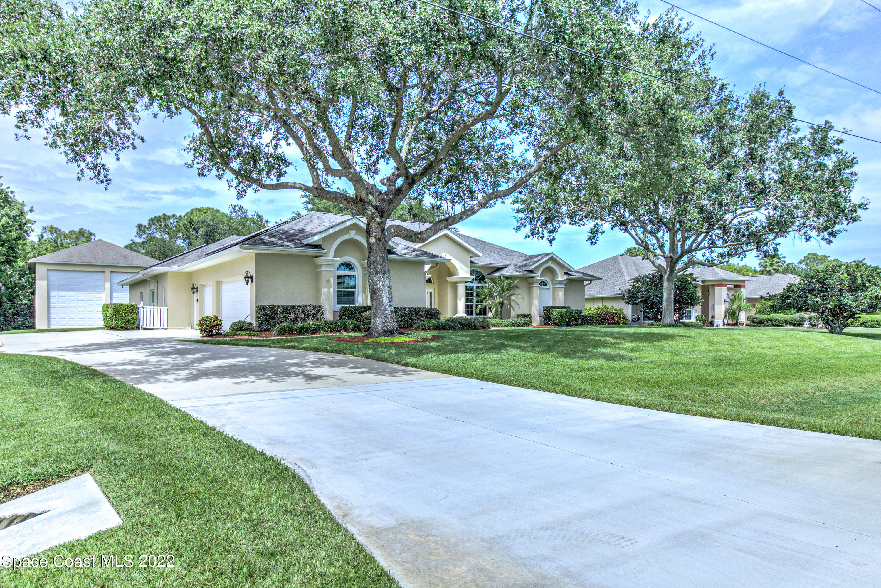 3415 Shady Run Road Melbourne, FL 32934 - Photo 32 of 45 a front view of a house with yard and green space