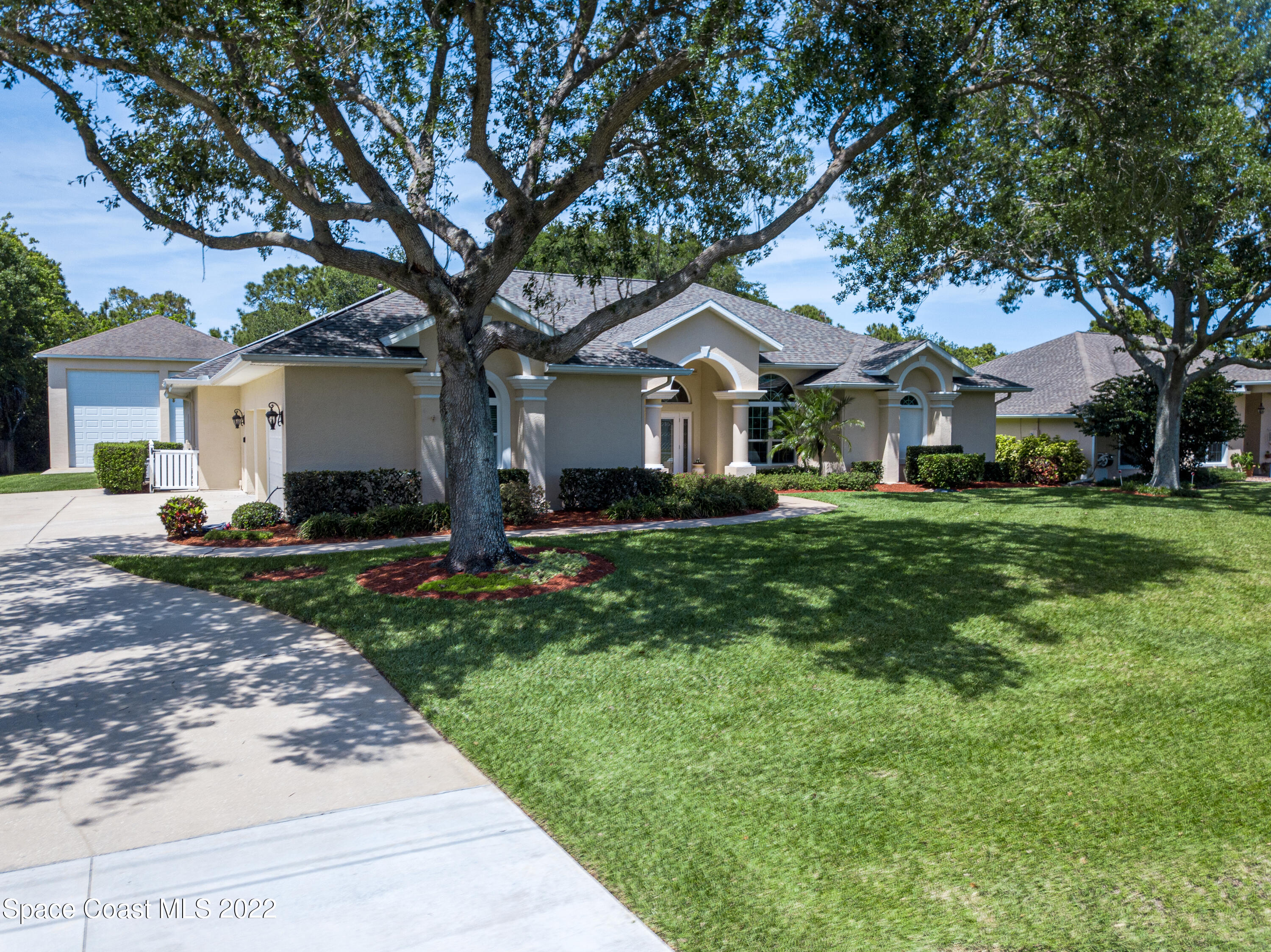 3415 Shady Run Road Melbourne, FL 32934 - Photo 33 of 45 a front view of a house with a garden