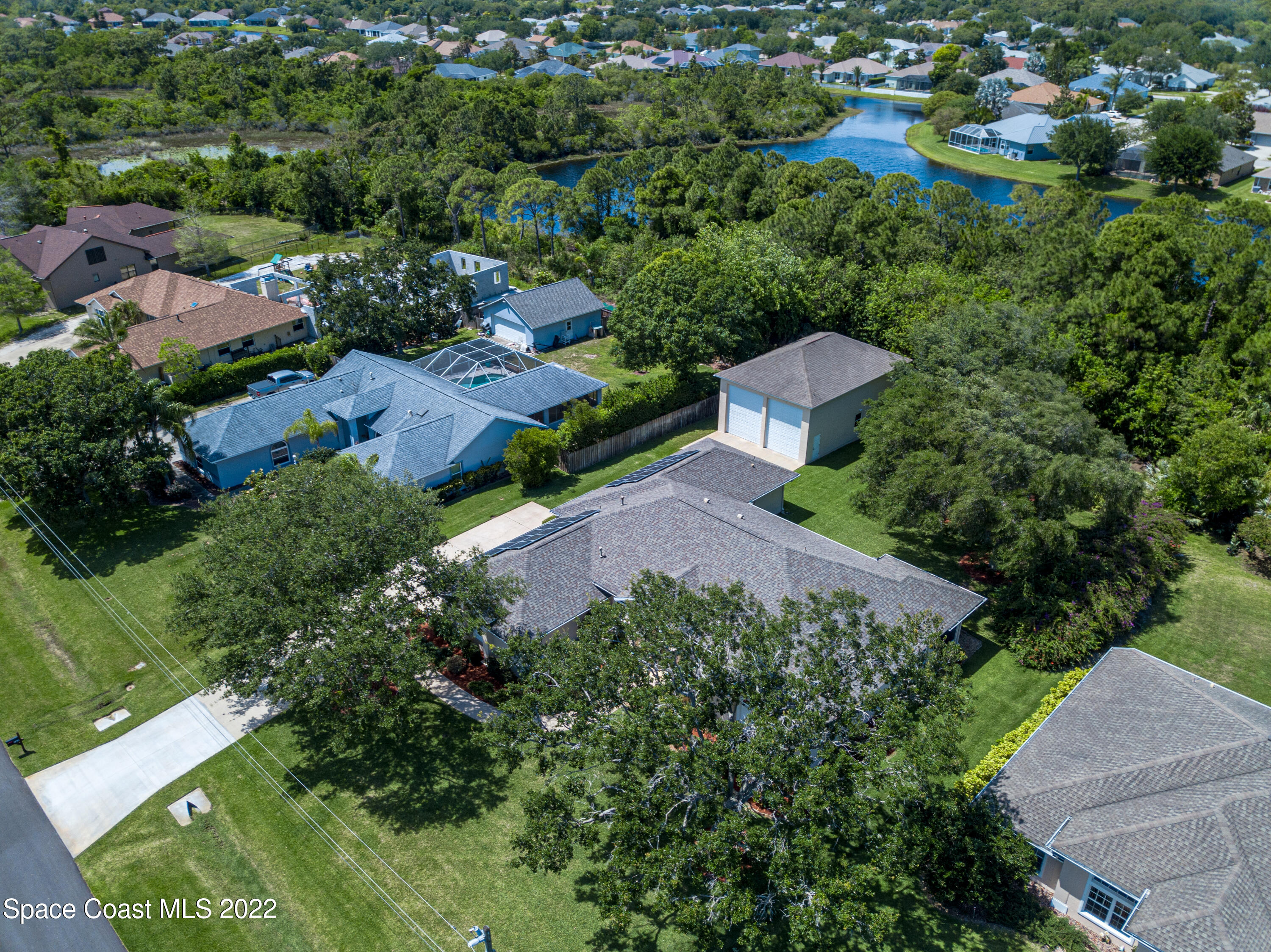 3415 Shady Run Road Melbourne, FL 32934 - Photo 42 of 45 an aerial view of a house with a yard and lake view