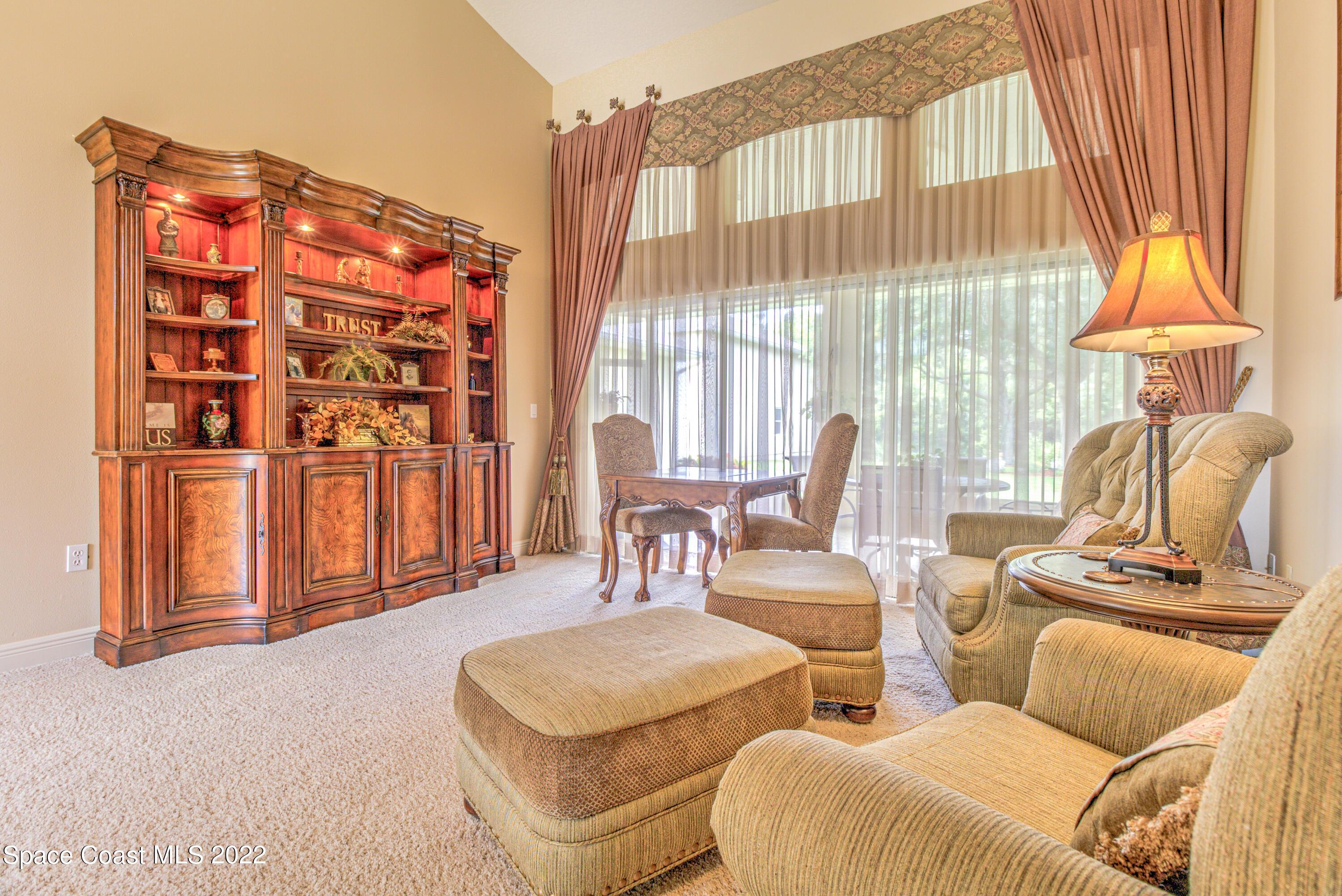 3415 Shady Run Road Melbourne, FL 32934 - Photo 5 of 45 a living room with furniture and a large window