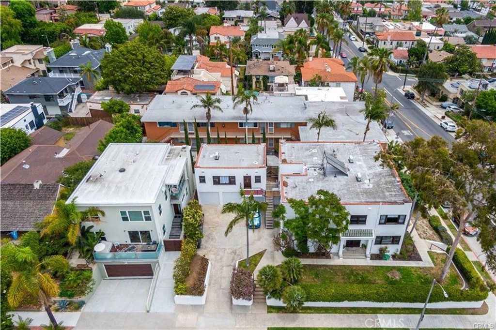 an aerial view of multiple houses with yard