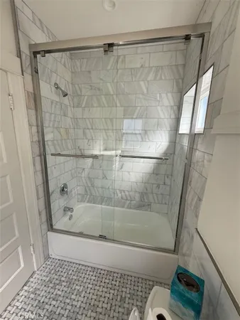 a bathroom with a shower and a toilet