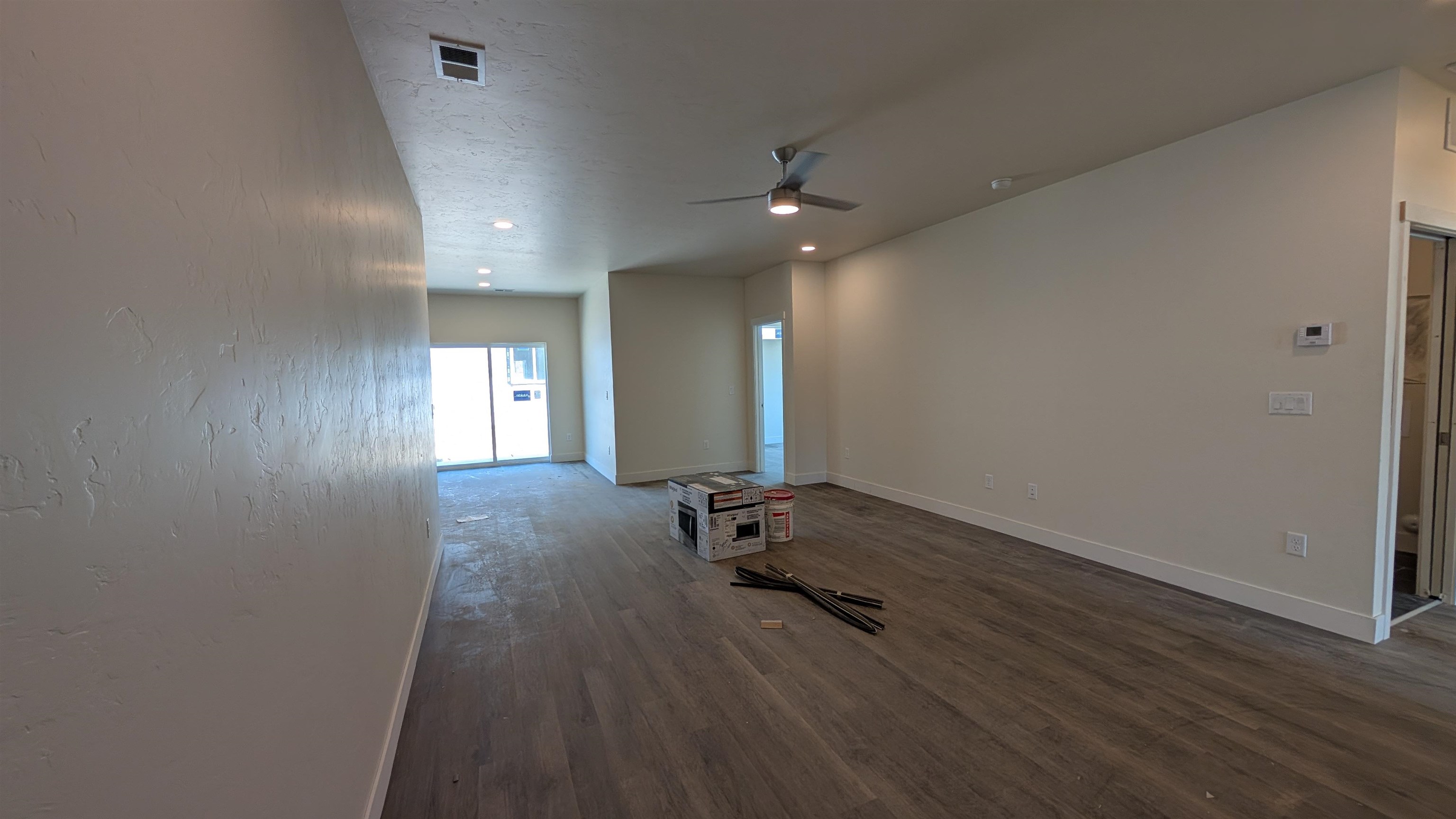 2452 Hamilton Road, Unit A Grand Junction, CO 81505 - Photo 3 of 13 an empty room with wooden floor and windows