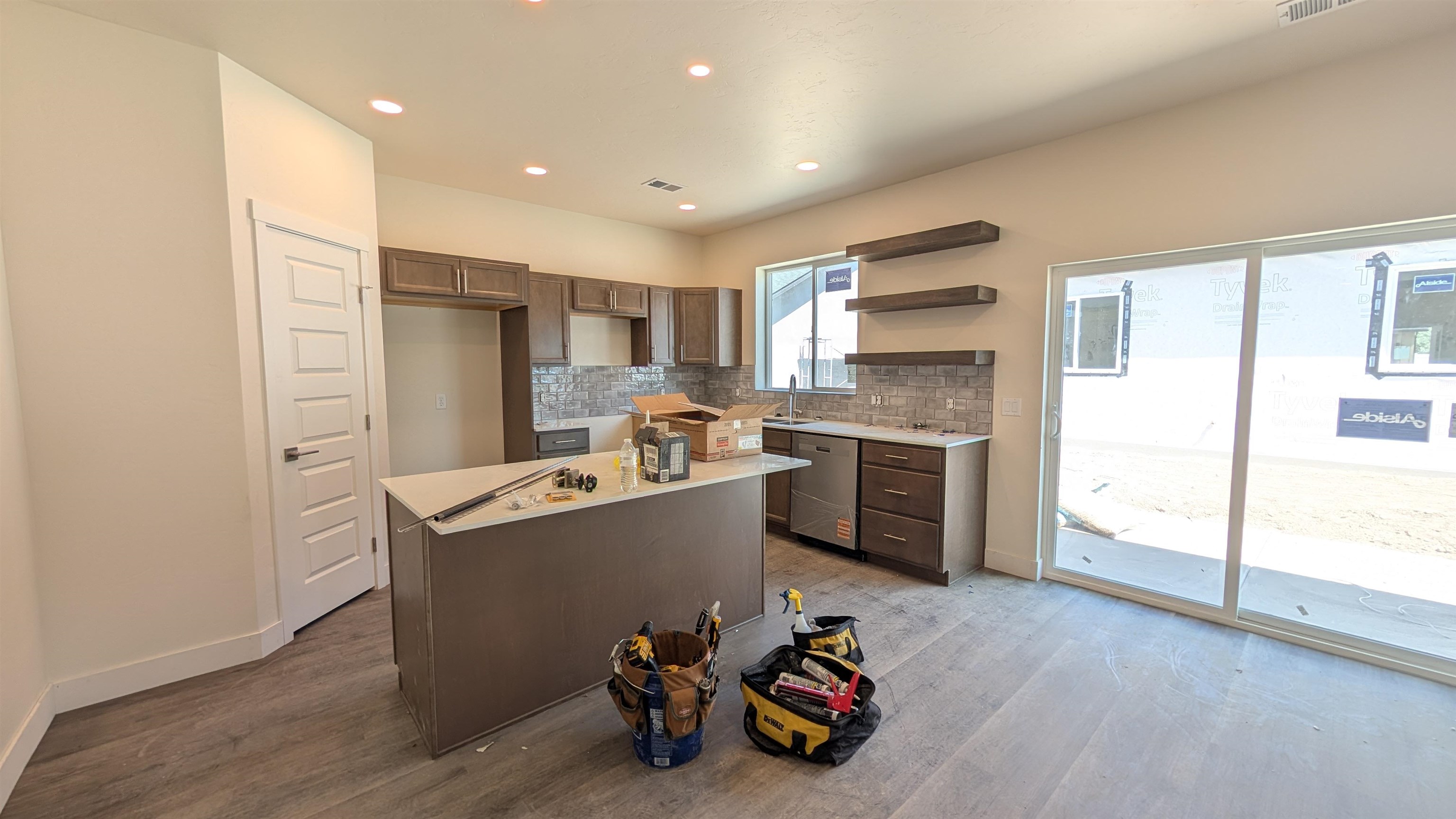 2452 Hamilton Road, Unit A Grand Junction, CO 81505 - Photo 4 of 13 a kitchen with kitchen island a stove a refrigerator and a sink with wooden floor