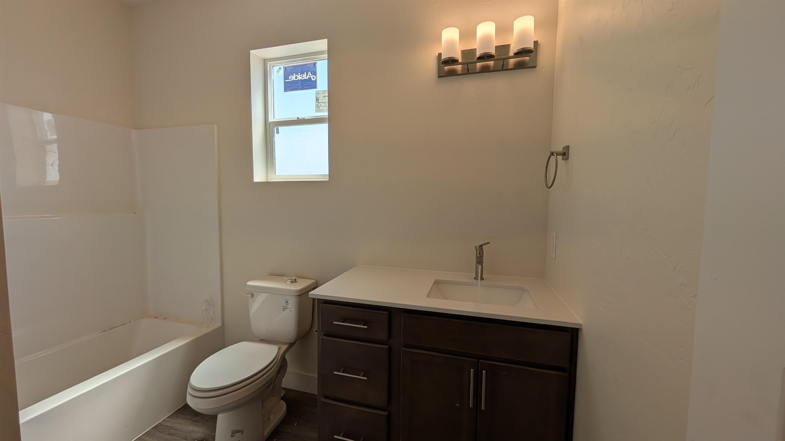 2452 Hamilton Road, Unit A Grand Junction, CO 81505 - Photo 8 of 13 a bathroom with a sink vanity mirror and toilet