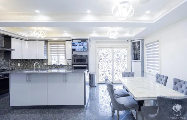 a large kitchen with lots of counter space and breakfast area