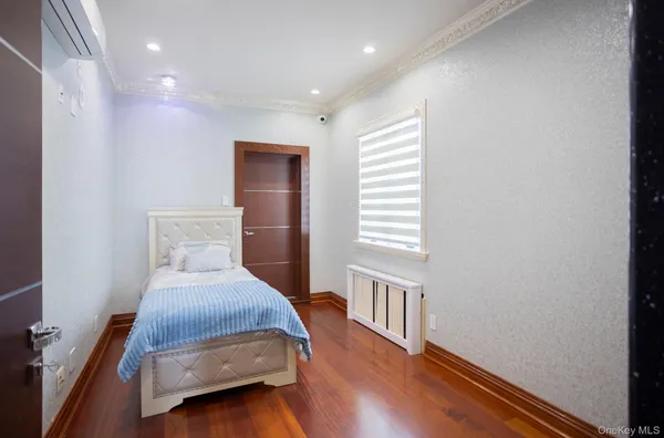 a bedroom with bed and a window