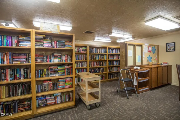 a kitchen with a stove a table and chairs in it
