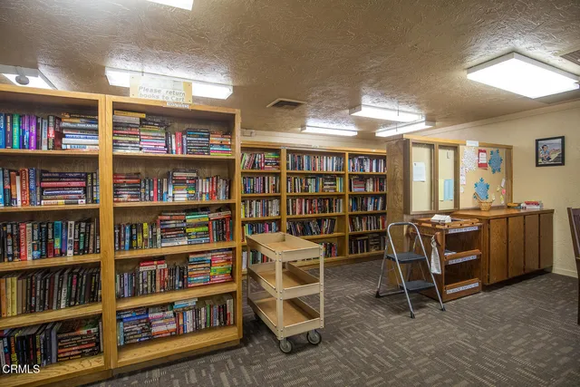a kitchen with a stove a table and chairs in it