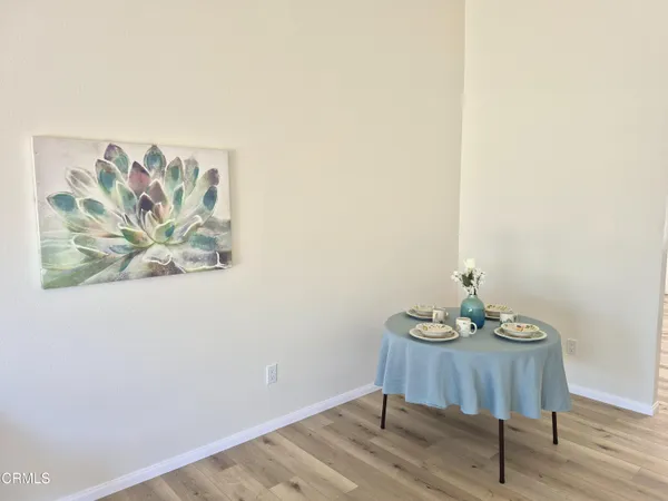 a view of a workspace with furniture and wooden floor