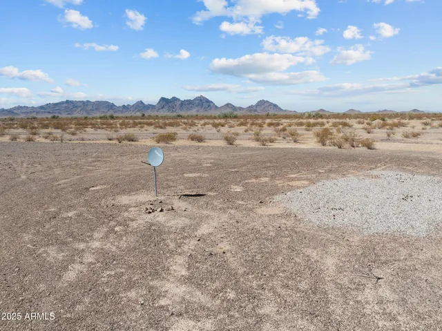 a view of a large mountain with mountains in the background