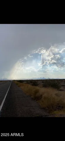 a view of mountains in the middle of a yard
