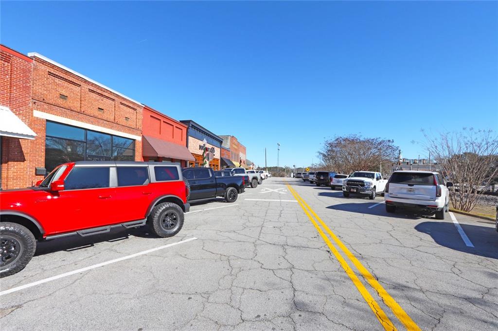 216 Main Street Bremen, GA 30110 - Photo 3 of 22 a view of a cars park in front of a building