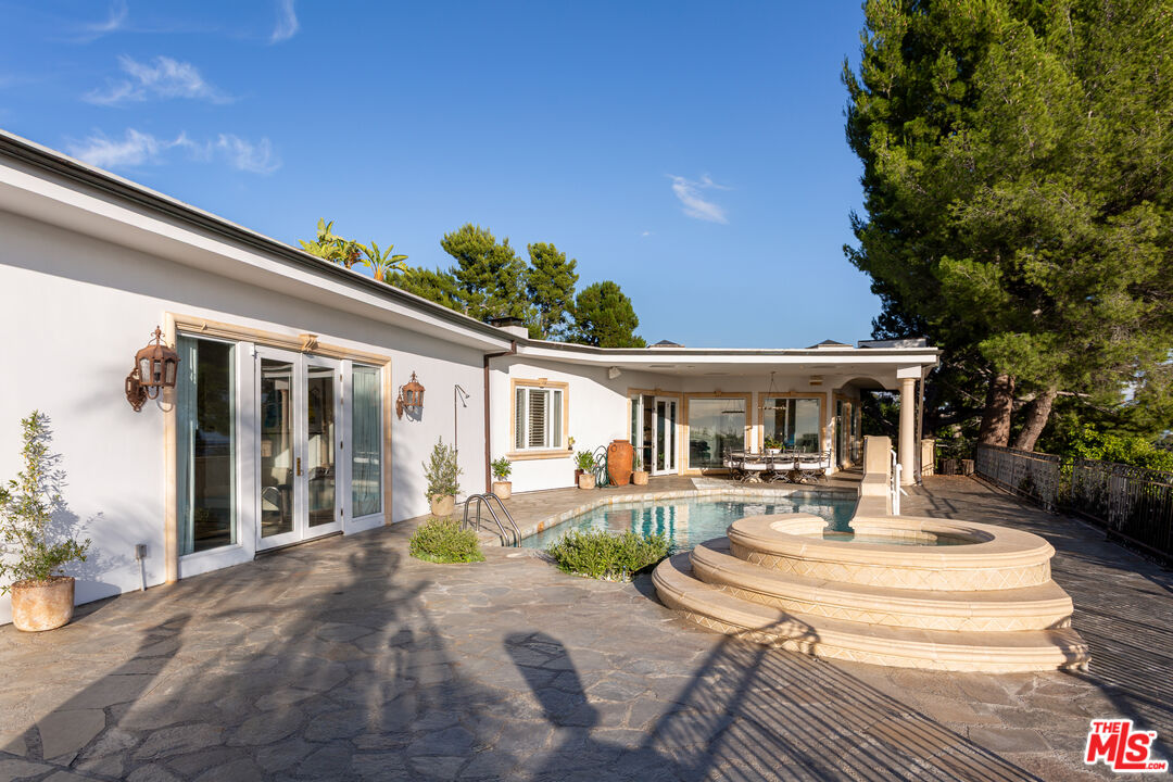 1491 Carla Ridge Beverly Hills, CA 90210 - Photo 25 of 63 a front view of a house with garden