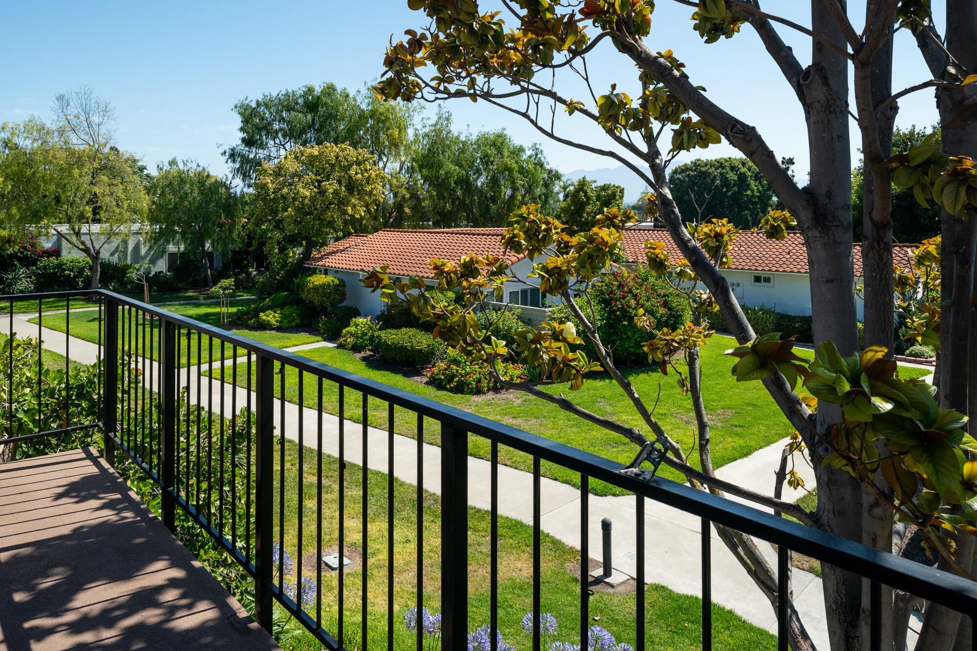 a view of a balcony with a yard