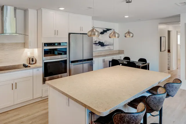 a kitchen with appliances cabinets and wooden floor
