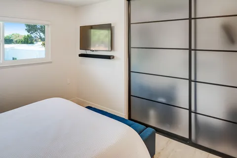 a bedroom with a bed and a window