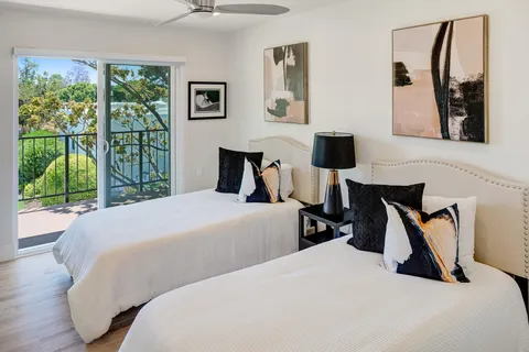 a bedroom with a bed and a large window