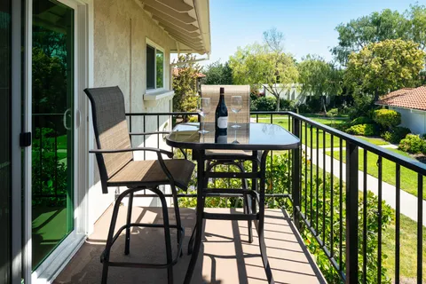 a view of balcony with furniture and garden