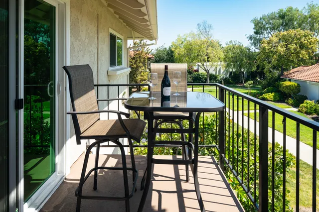a view of balcony with furniture and garden