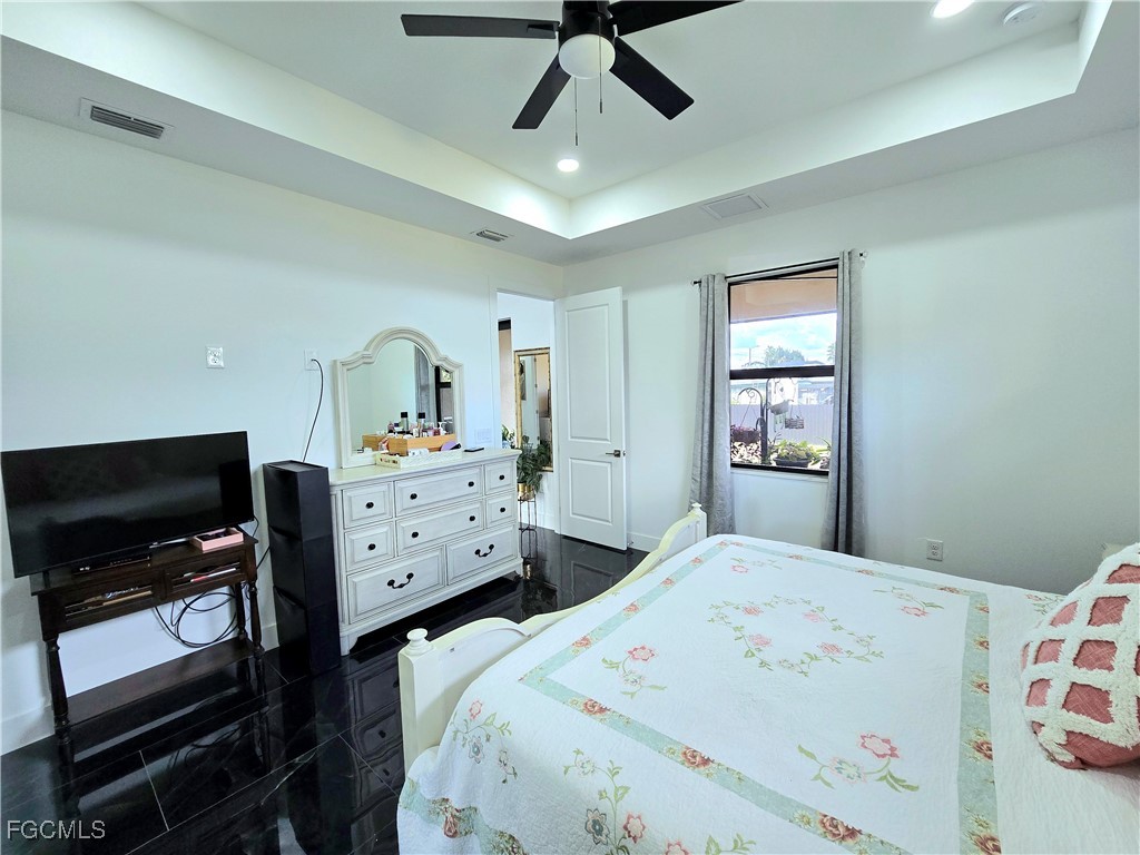 705 Harding Lane Lehigh Acres, FL 33936 - Photo 15 of 38 a bedroom with a bed and a tv on the dresser